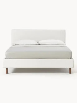 Cama tapizada con patas de madera Giulia