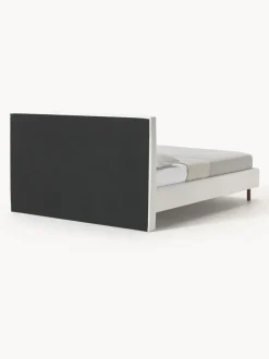 Cama tapizada con patas de madera Giulia
