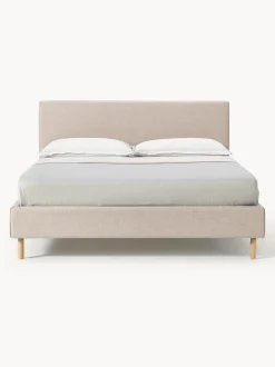 Cama tapizada con patas de madera Giulia