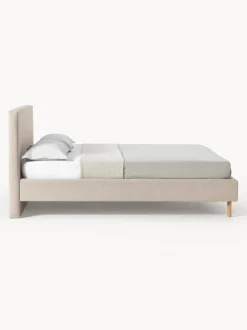 Cama tapizada con patas de madera Giulia
