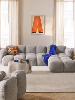 Sofá modular en tejido bouclé con reposapiés Tayla (4 plazas)